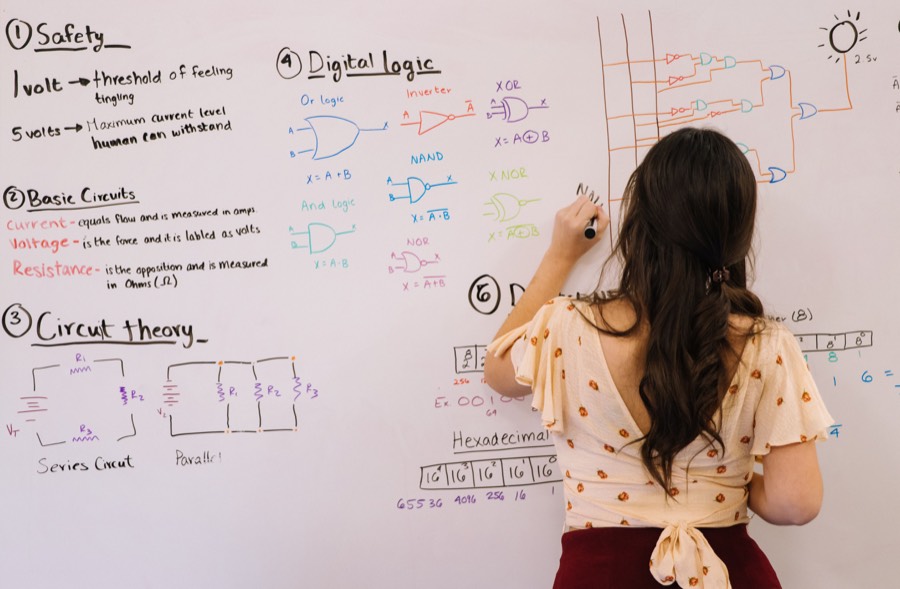 Tutor explaining digital logic on a whiteboard