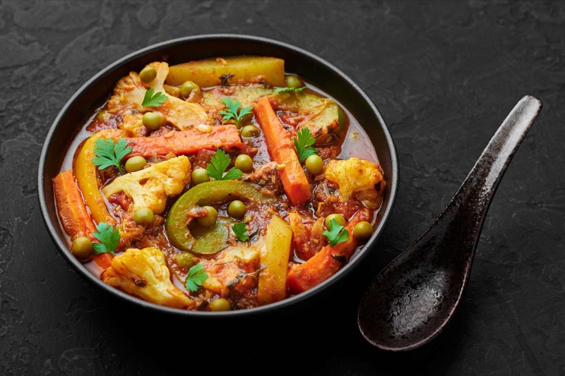 Home-style vegetable curry in a black bowl